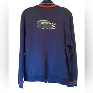 Lacoste navy zip-up jacket with a large embroidered crocodile logo on the back